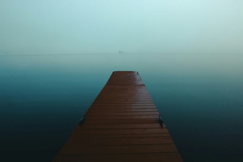 Self awareness coaching in Cornwall — a calm ocean jetty at Dhama Sun with Jo Tooth